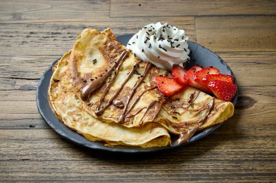 plate of crepes on wooden table